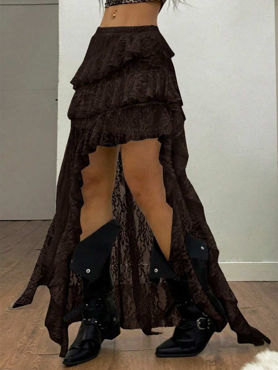 Women's low rise asymmetrical long skirt with ruffle hem detailing in semi-sheer knitted fabric.