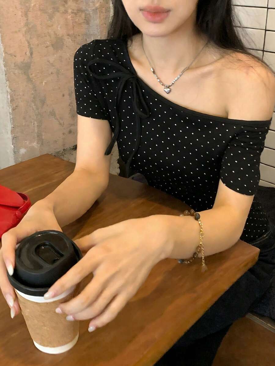 Women's casual short sleeve t-shirt with an asymmetrical neck in a loose fit knitted fabric.