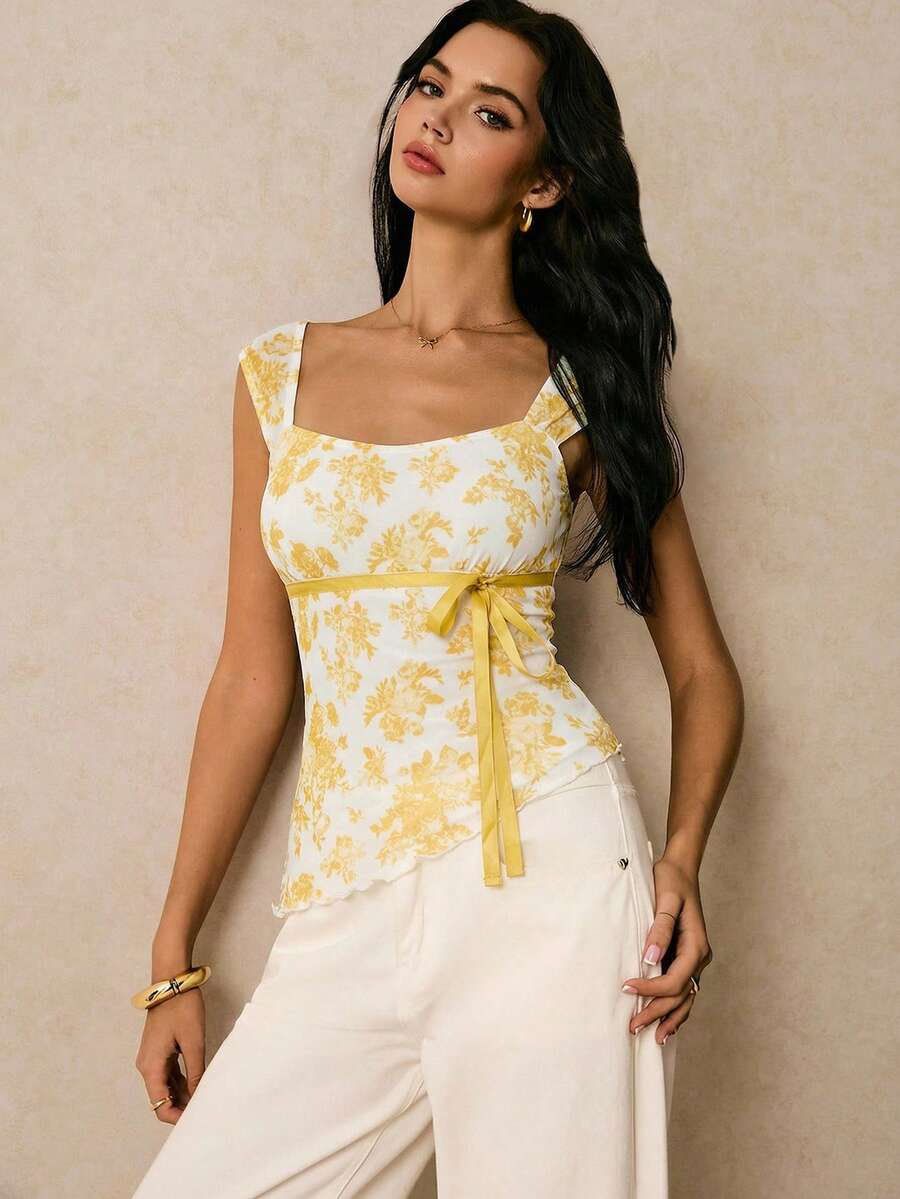 Women's dusty pink floral print mesh tank top featuring a square neckline, ruched bust with a tie-front knot, and an asymmetrical hem.