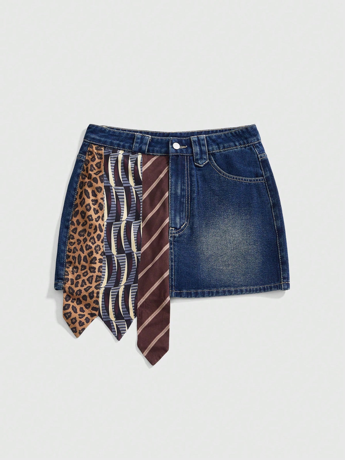 Women's low-waist asymmetrical mini skort featuring button, zipper, and pocket details in an A-line cut.