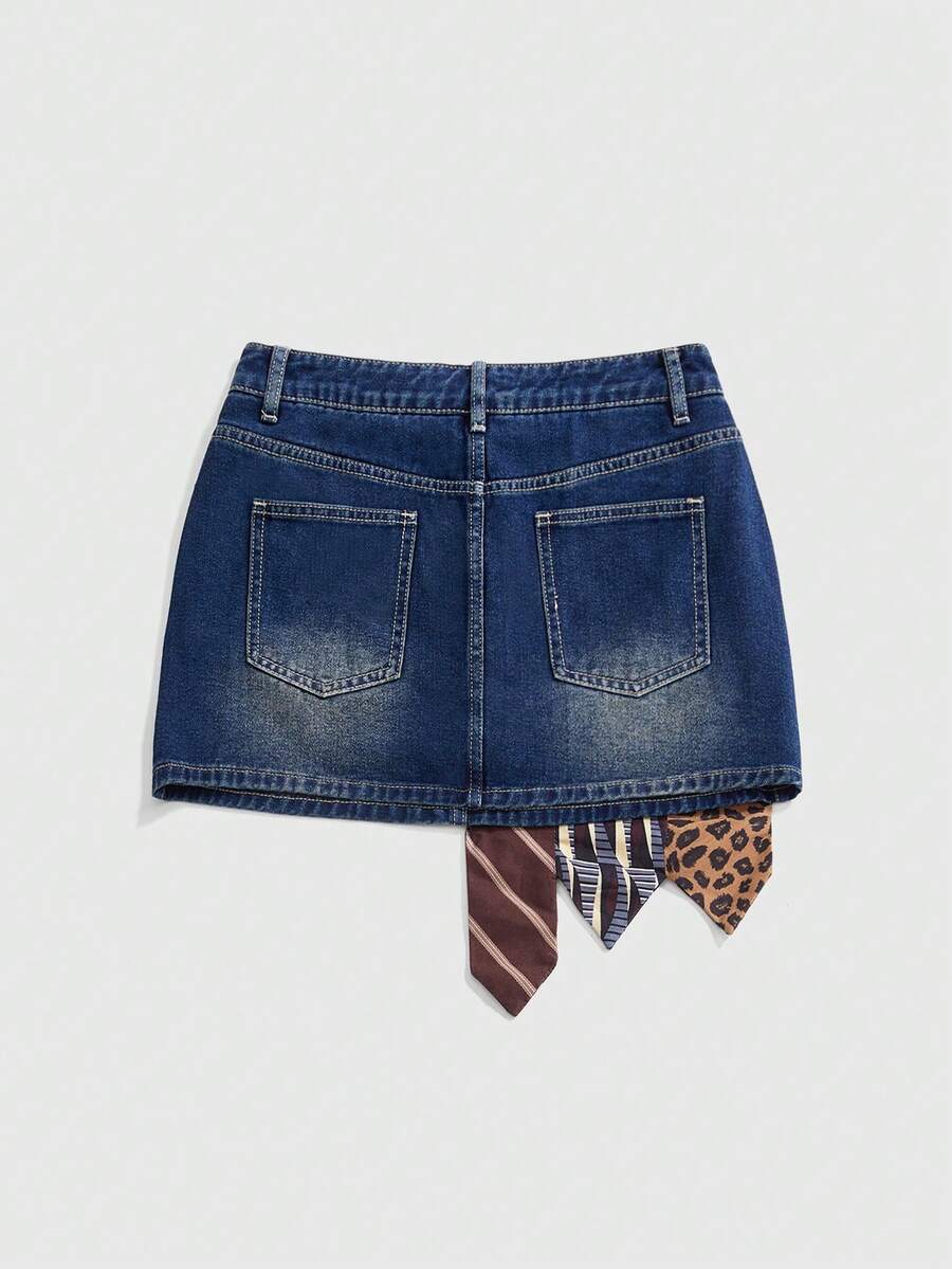 Women's low-waist asymmetrical mini skort featuring button, zipper, and pocket details in an A-line cut.