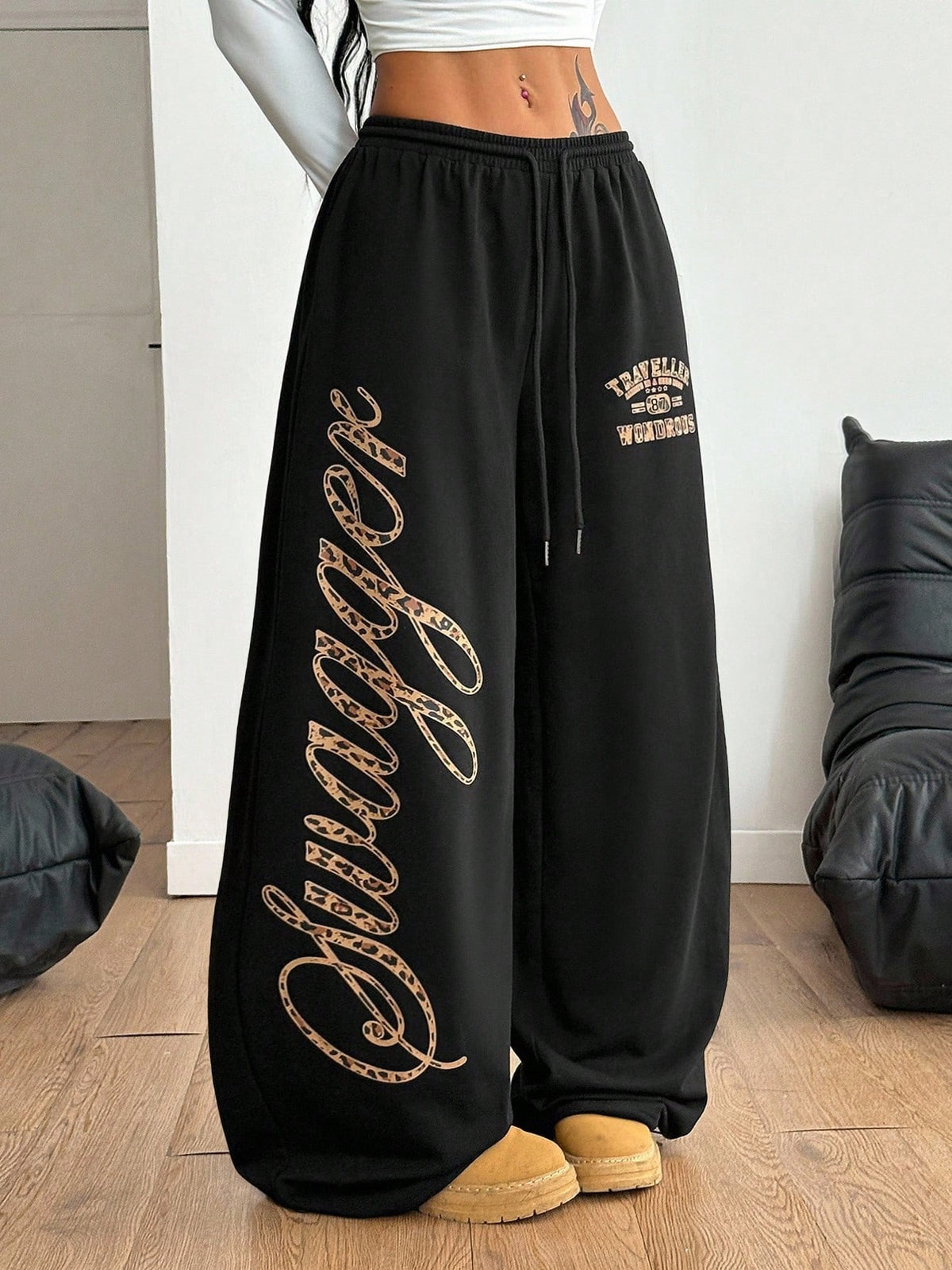 Women's loose fit wide leg graphic sweatpants in light grey with an elastic drawstring waistband