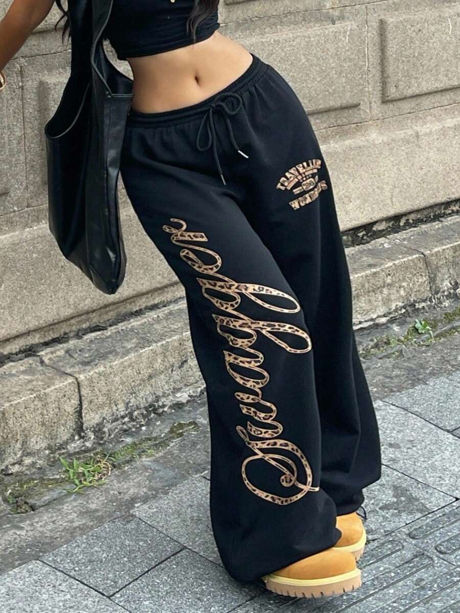Women's loose fit wide leg graphic sweatpants in light grey with an elastic drawstring waistband