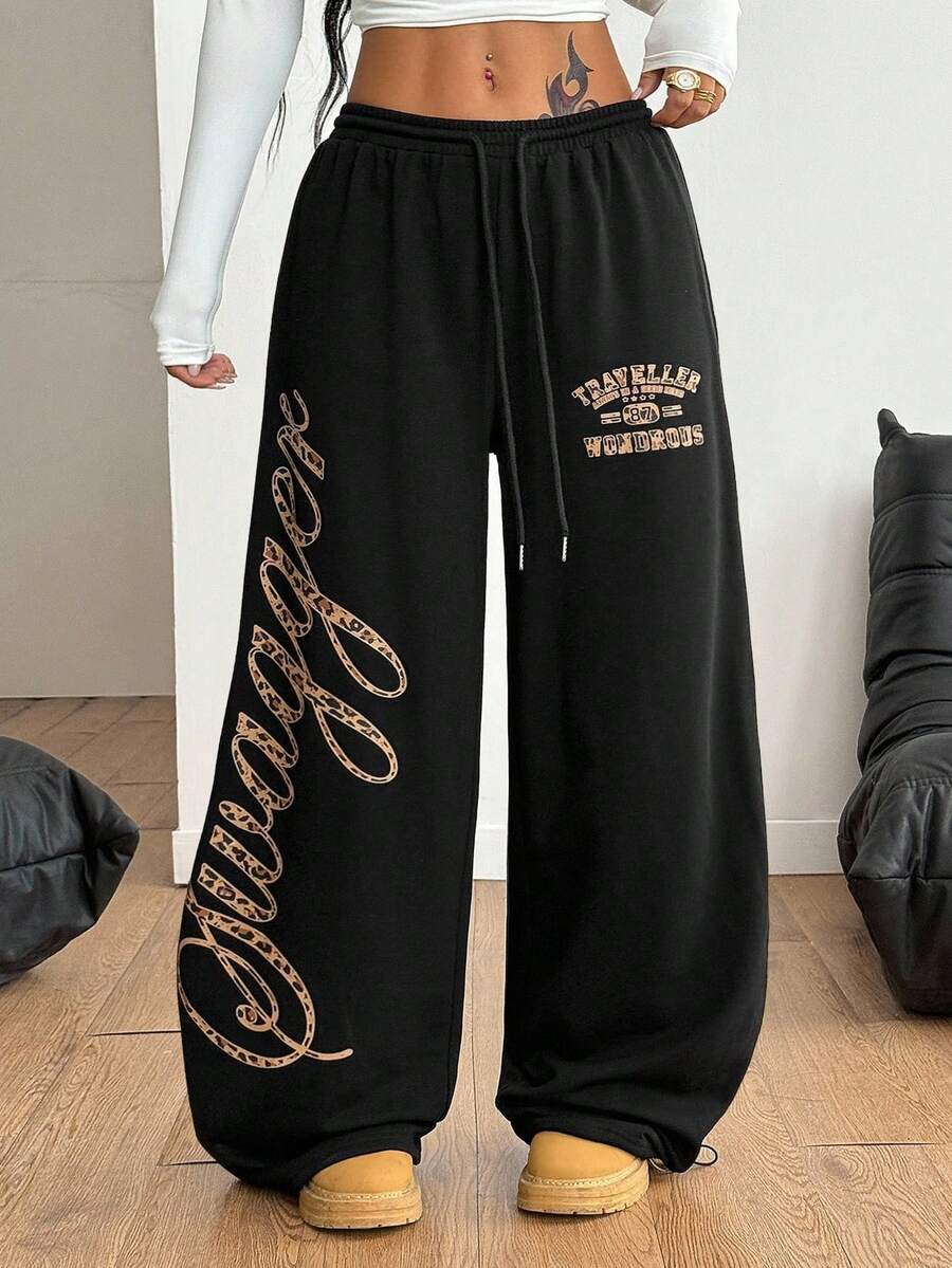 Women's loose fit wide leg graphic sweatpants in light grey with an elastic drawstring waistband