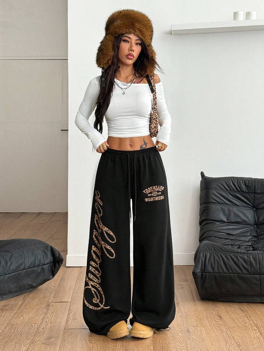 Women's loose fit wide leg graphic sweatpants in light grey with an elastic drawstring waistband