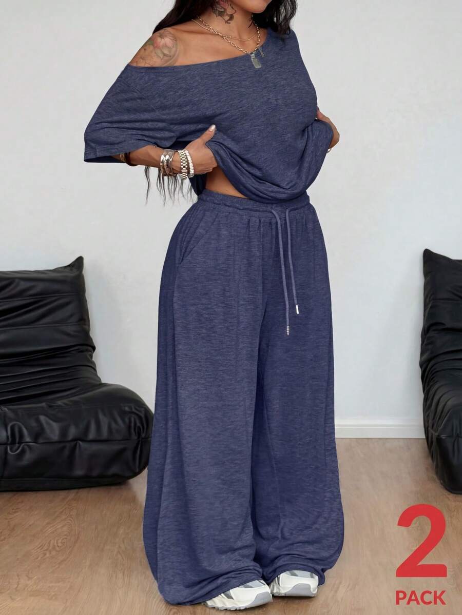 Women's casual two-piece outfit featuring a loose short-sleeve asymmetrical neck t-shirt and matching long wide leg pants with pockets.