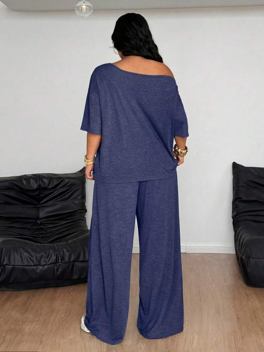 Women's casual two-piece outfit featuring a loose short-sleeve asymmetrical neck t-shirt and matching long wide leg pants with pockets.