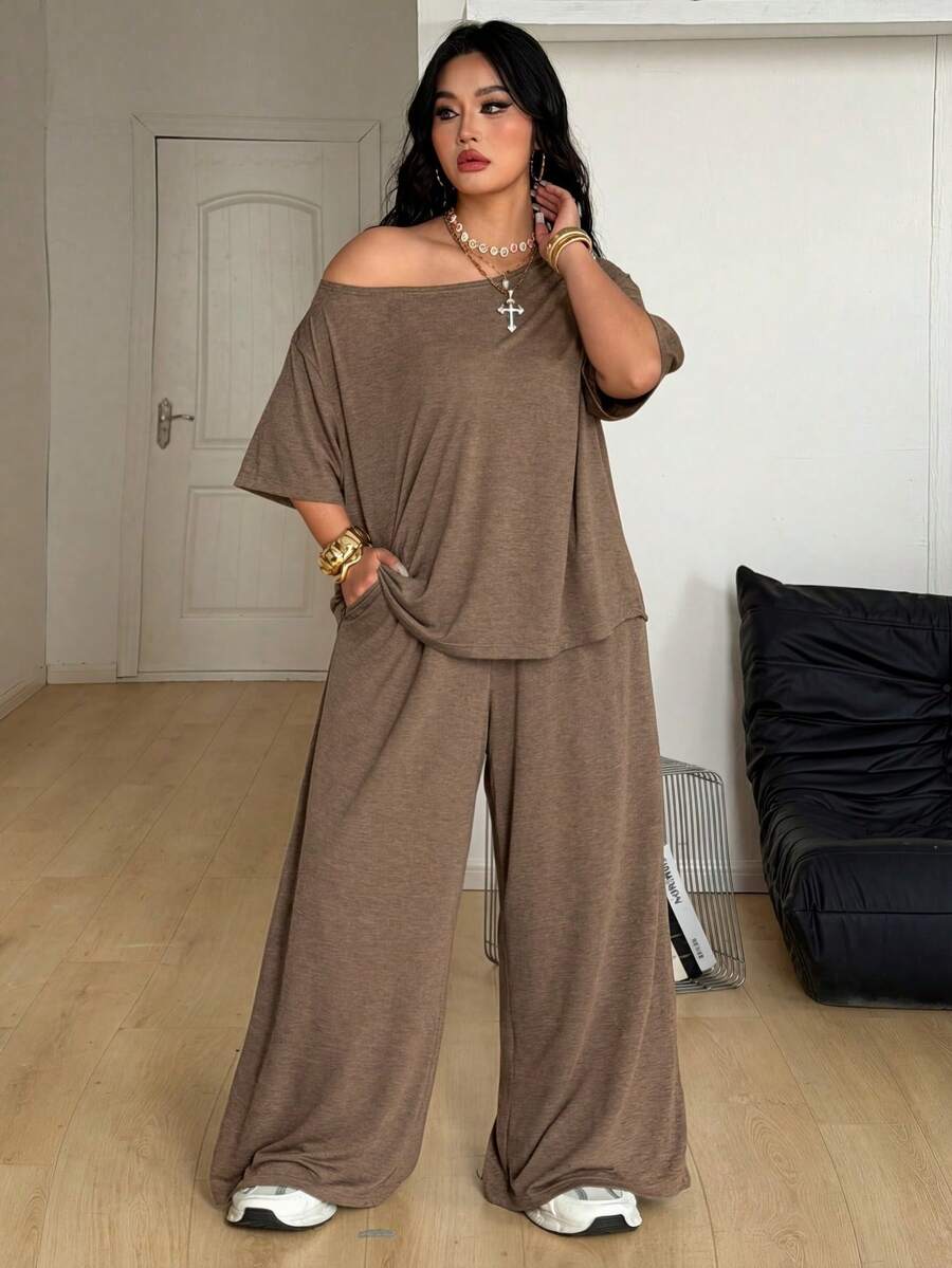 Women's casual two-piece outfit featuring a loose short-sleeve asymmetrical neck t-shirt and matching long wide leg pants with pockets.