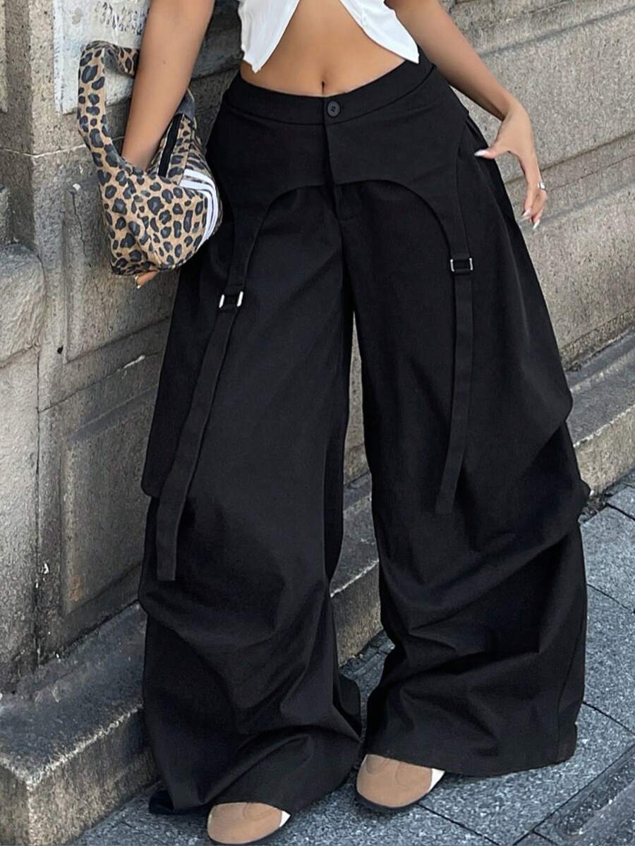 Women's plus size black wide leg parachute pants featuring an asymmetric high waist design in woven fabric.