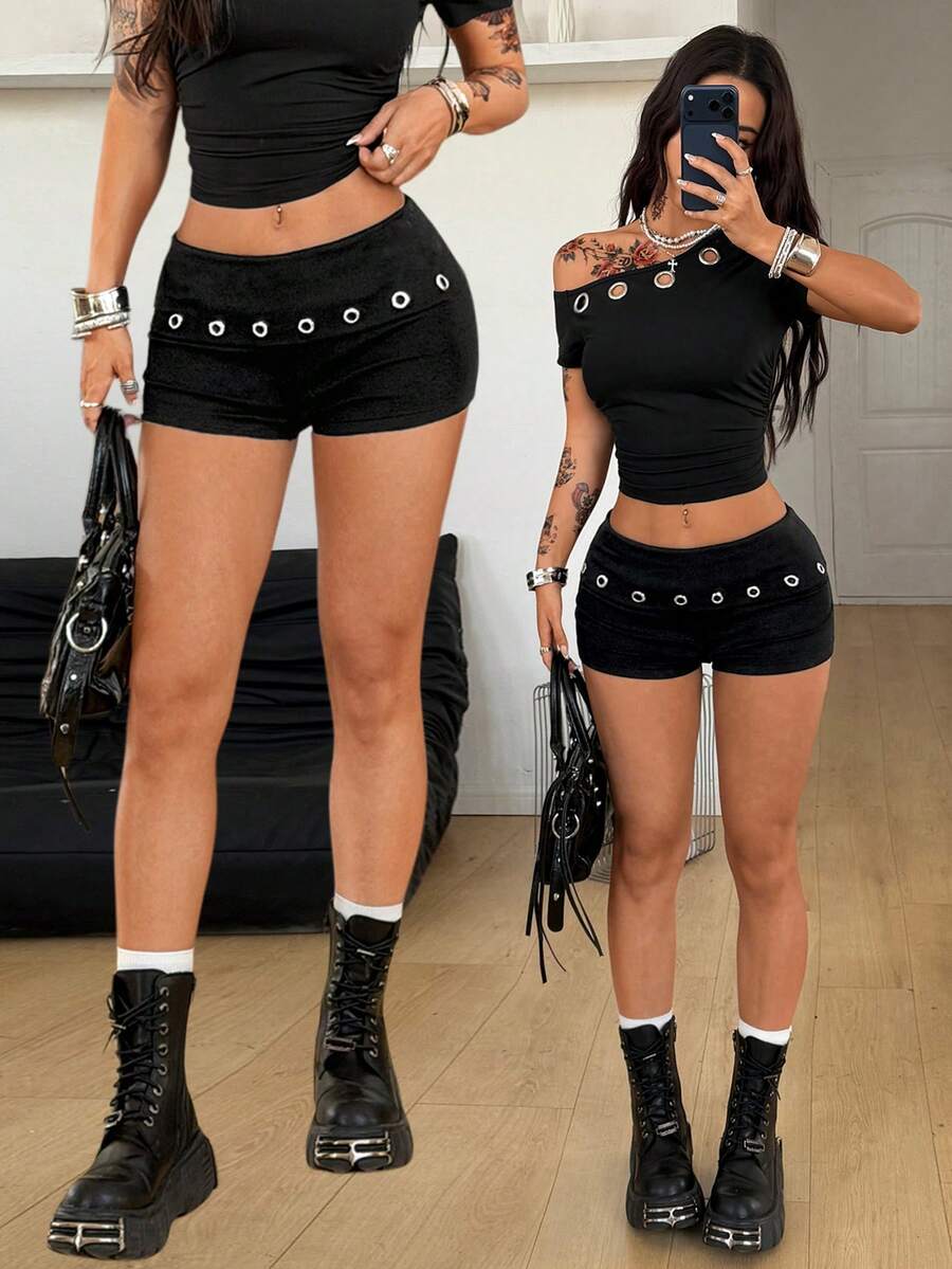 Women's black ultra low rise mini shorts with grommet eyelet and rib-knit details, zipper fly closure, skinny straight-leg fit, and plain knitted fabric.