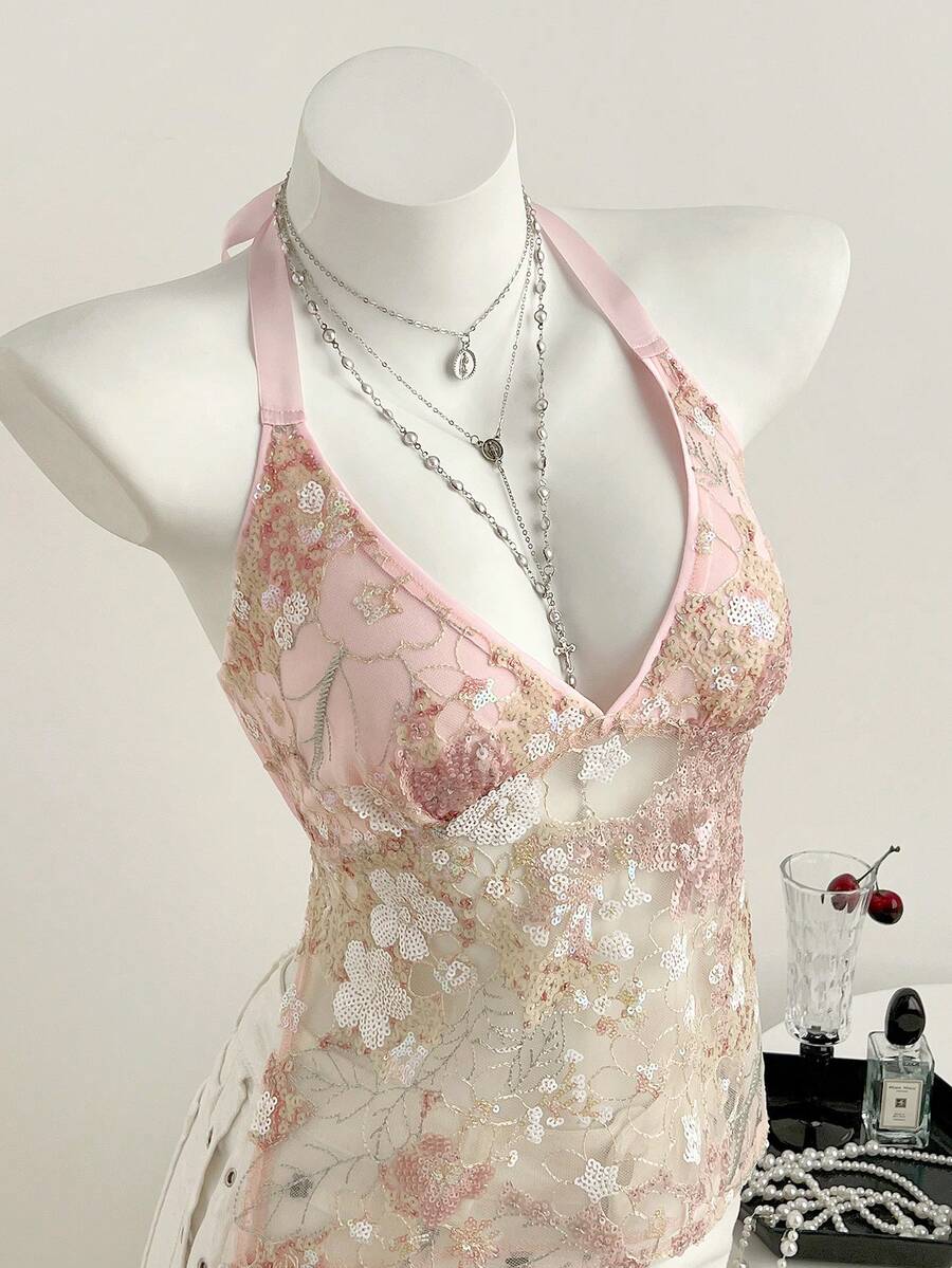 Pink sheer lace tie-up halter crop top featuring floral sequin patchwork, deep V-neck, and backless tie-back design.
