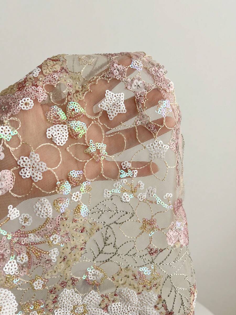 Pink sheer lace tie-up halter crop top featuring floral sequin patchwork, deep V-neck, and backless tie-back design.