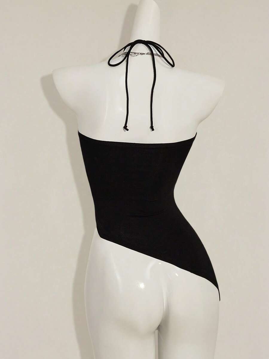 Women's black asymmetrical knitted halter top featuring a slim fit and colorblock pattern
