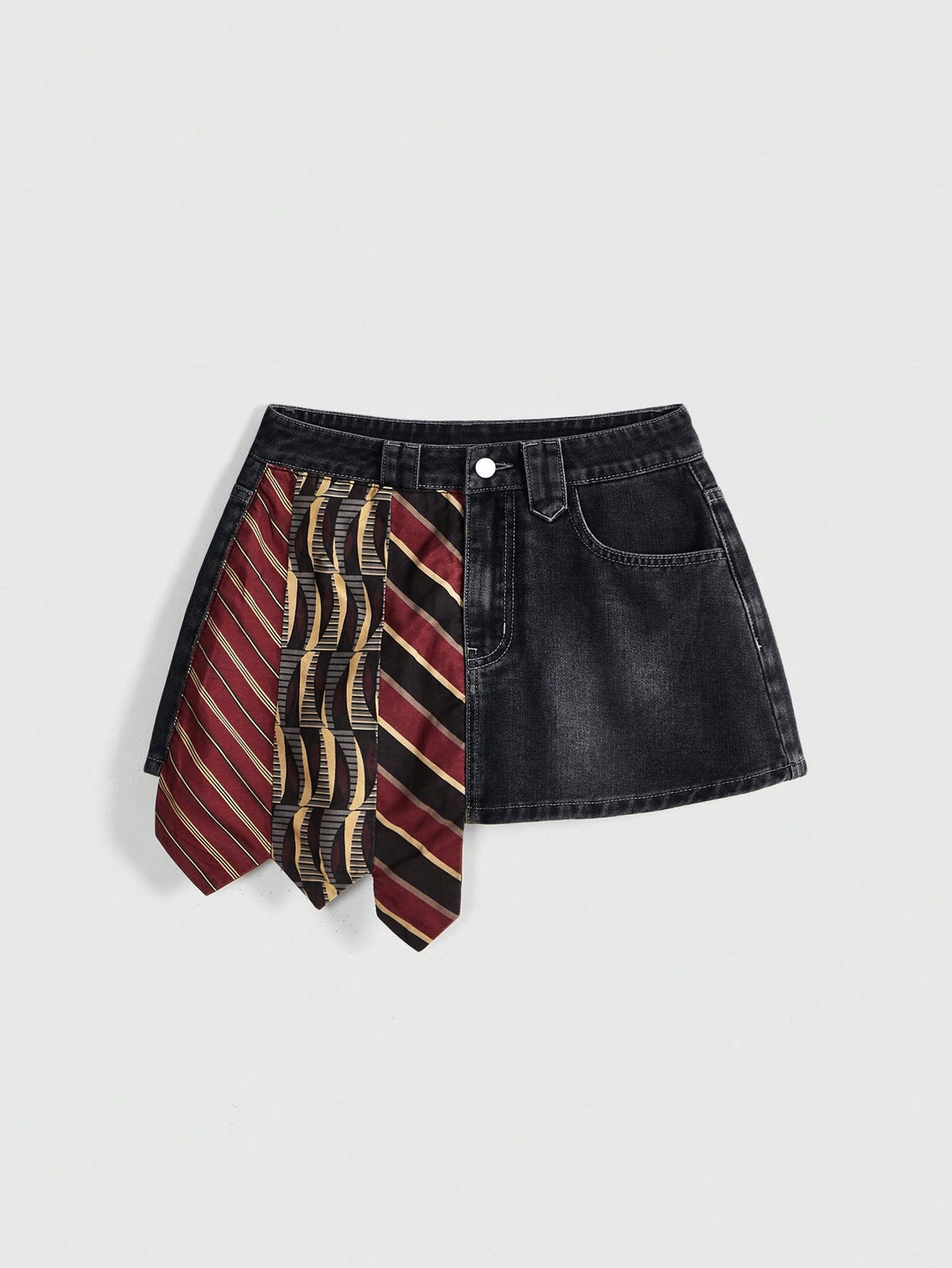 Women's low-waist asymmetrical mini skort featuring button, zipper, and pocket details in an A-line cut.