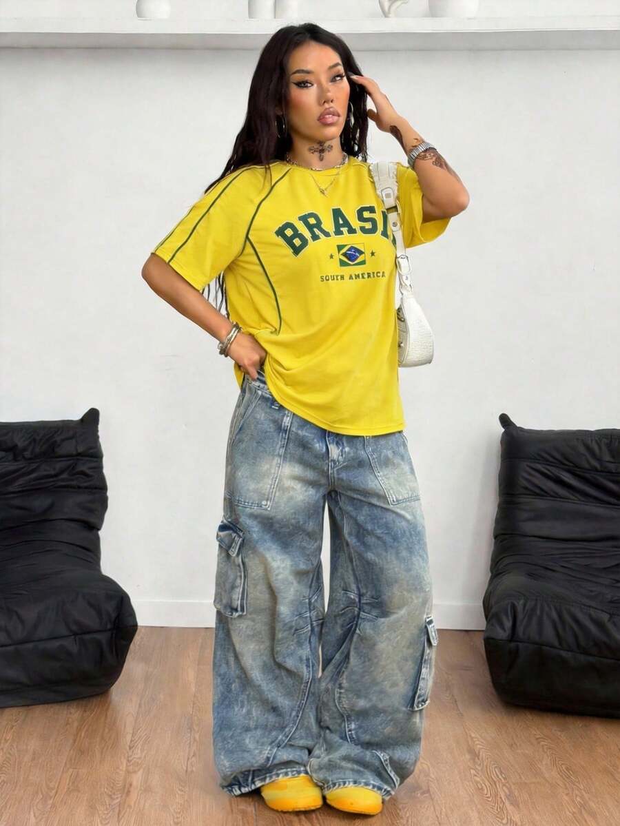 Yellow oversized graphic t-shirt featuring Brazil letter print on the front with contrast raglan sleeves and side stripe detailing.