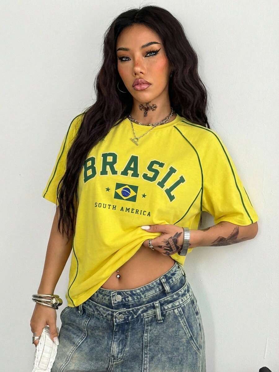 Yellow oversized graphic t-shirt featuring Brazil letter print on the front with contrast raglan sleeves and side stripe detailing.