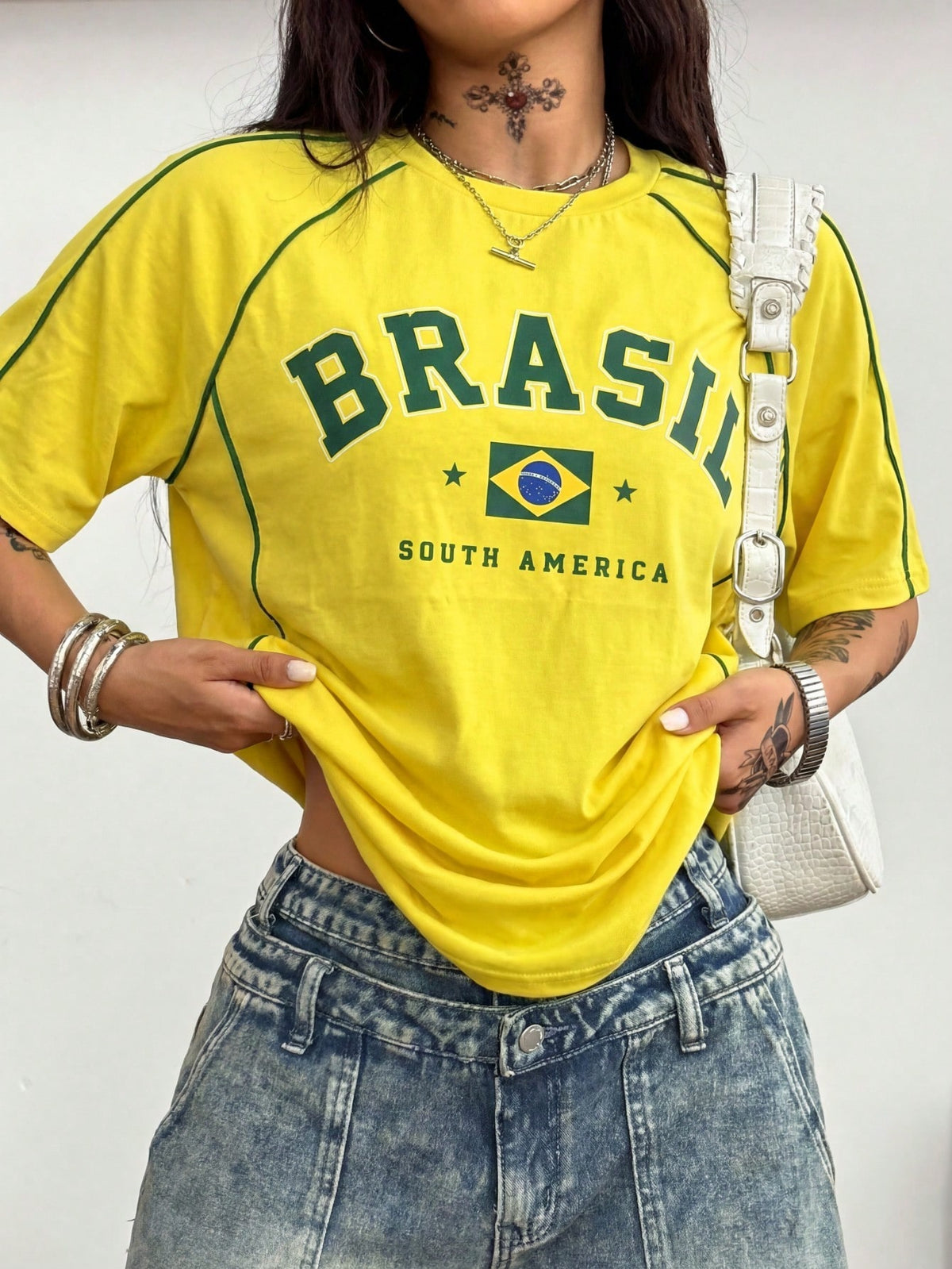 Yellow oversized graphic t-shirt featuring Brazil letter print on the front with contrast raglan sleeves and side stripe detailing.