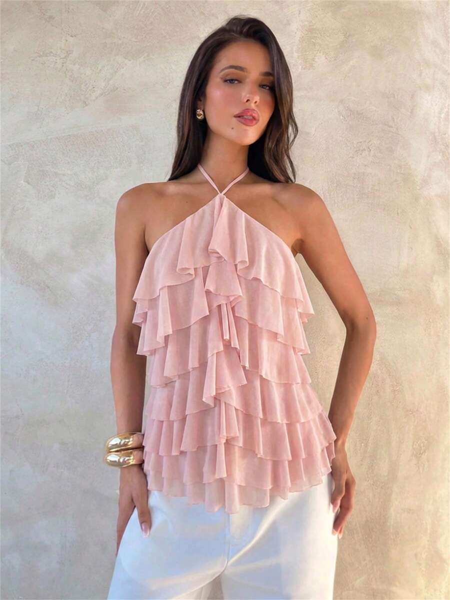Women's sleeveless halter neck top featuring tiered ruffle layers, a backless cut, and an asymmetrical hem.