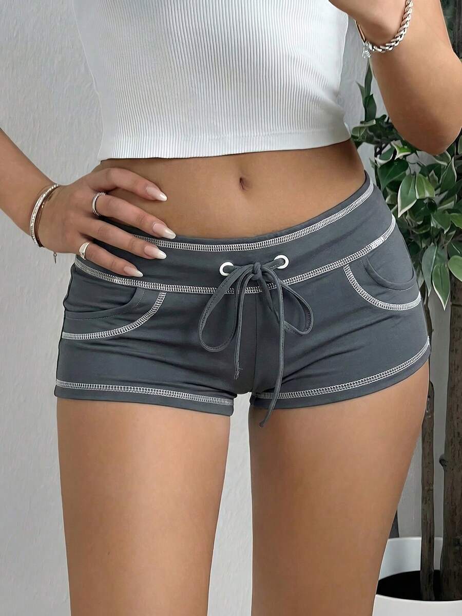 Women's low waist track shorts with drawstring waist, zipper detail, and mini length in a casual skinny fit