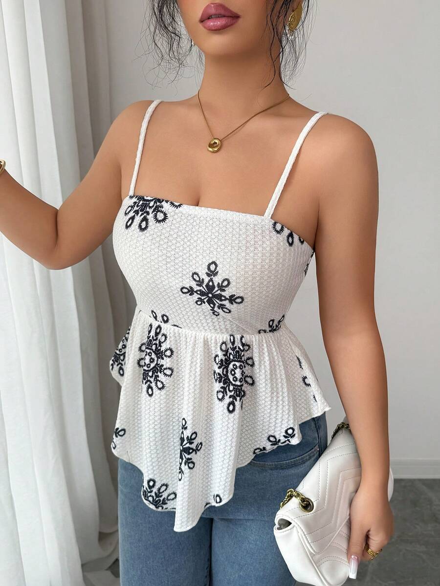 Women's floral snowflake print camisole top featuring spaghetti straps, slim fit, and an asymmetrical hem in navy blue knit fabric.