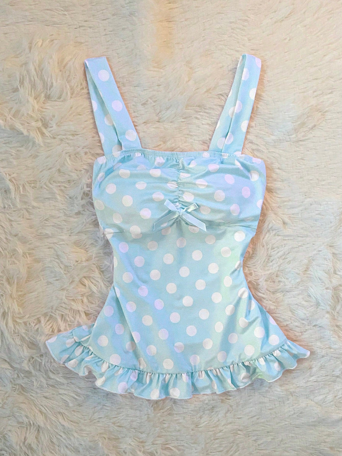 Women's retro slim-fit crop top featuring wide straps, ruched shirred detailing, asymmetrical ruffle hem, and cute bow accent.