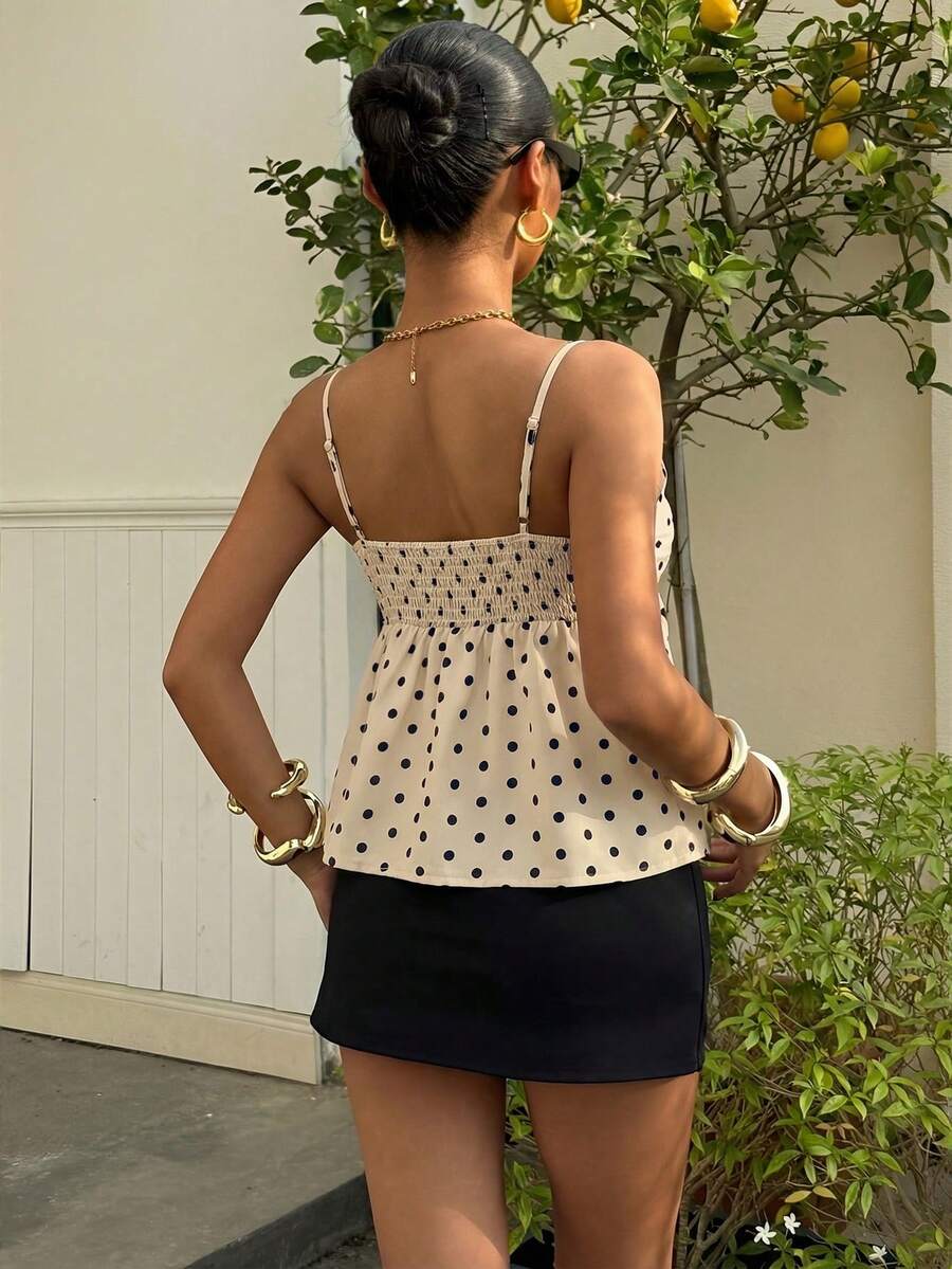 Women's casual geometric cami top with spaghetti straps, backless wrap styling, button front, and asymmetrical hem.