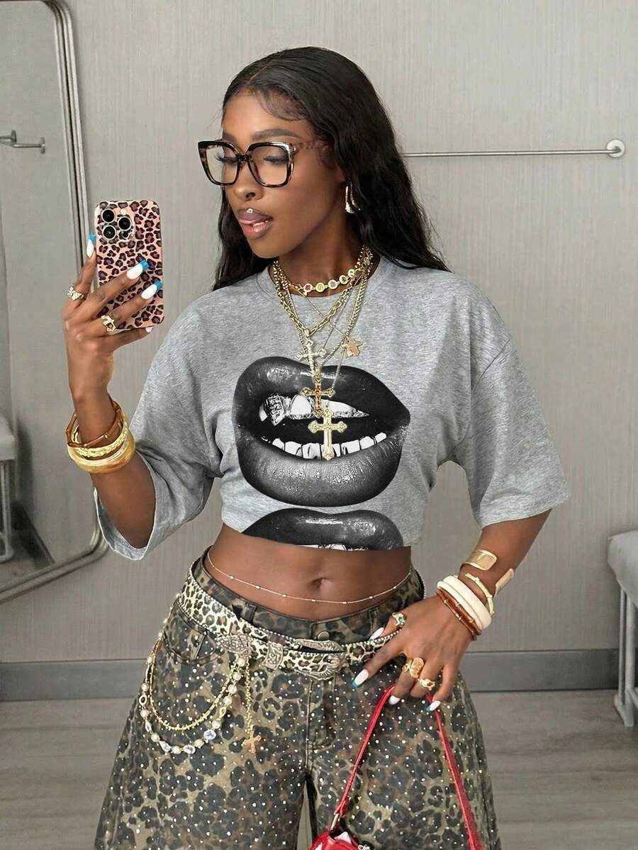 Women's oversized graphic crew neck t-shirt made of 100% white cotton knitted fabric with drop shoulder half sleeves.