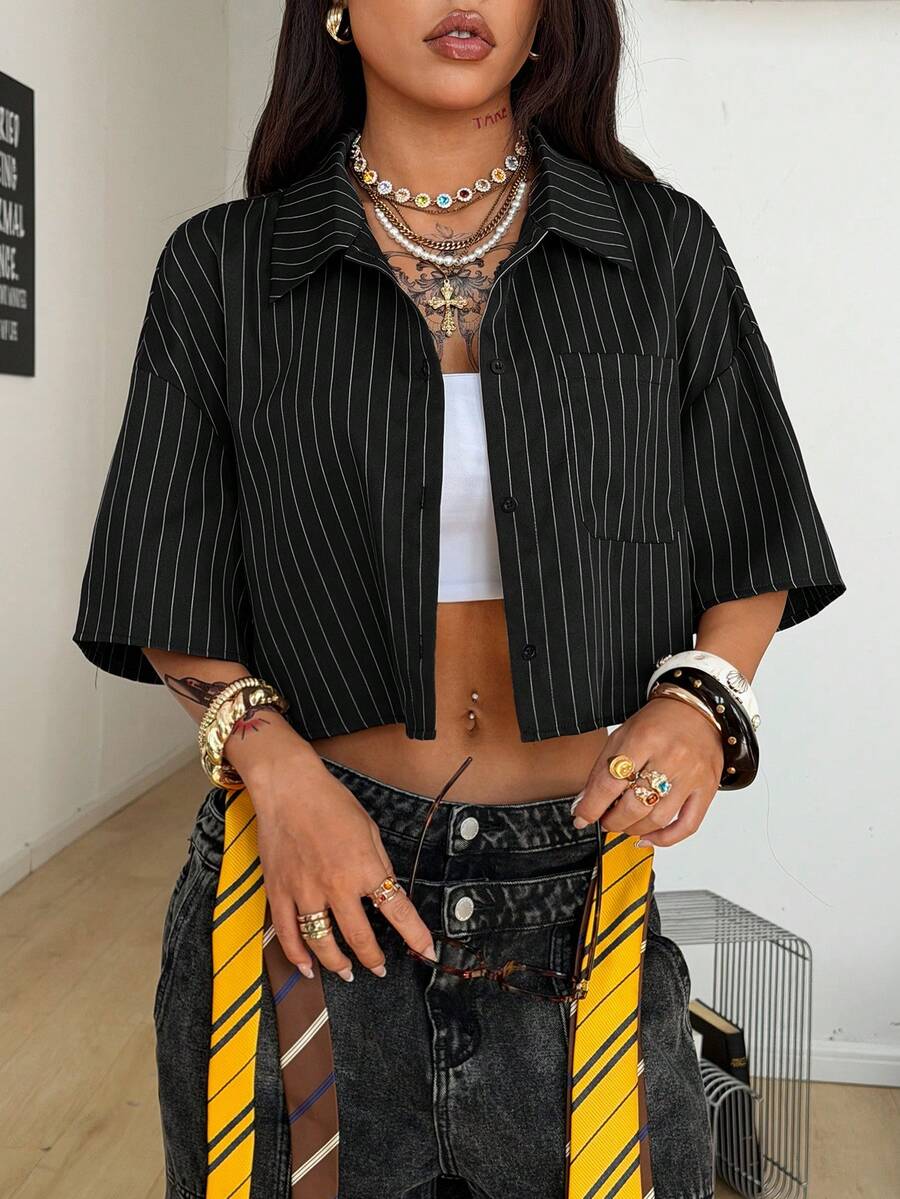 Women's plaid crop shirt with button front, chest pocket, short sleeves, and loose casual fit.