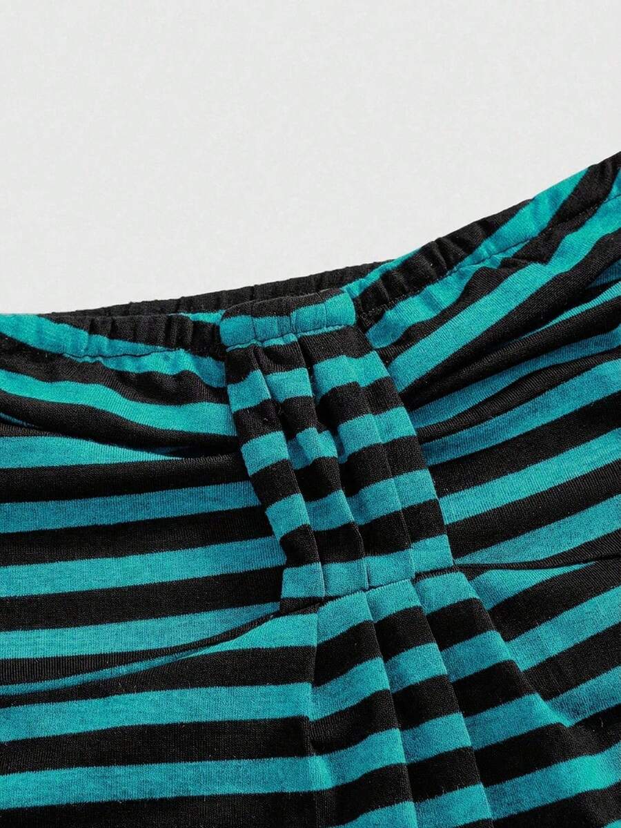 Women's striped strapless tube top featuring ruched detailing, flared hem, and stretchy knit fabric.