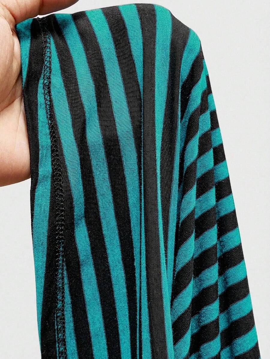 Women's striped strapless tube top featuring ruched detailing, flared hem, and stretchy knit fabric.