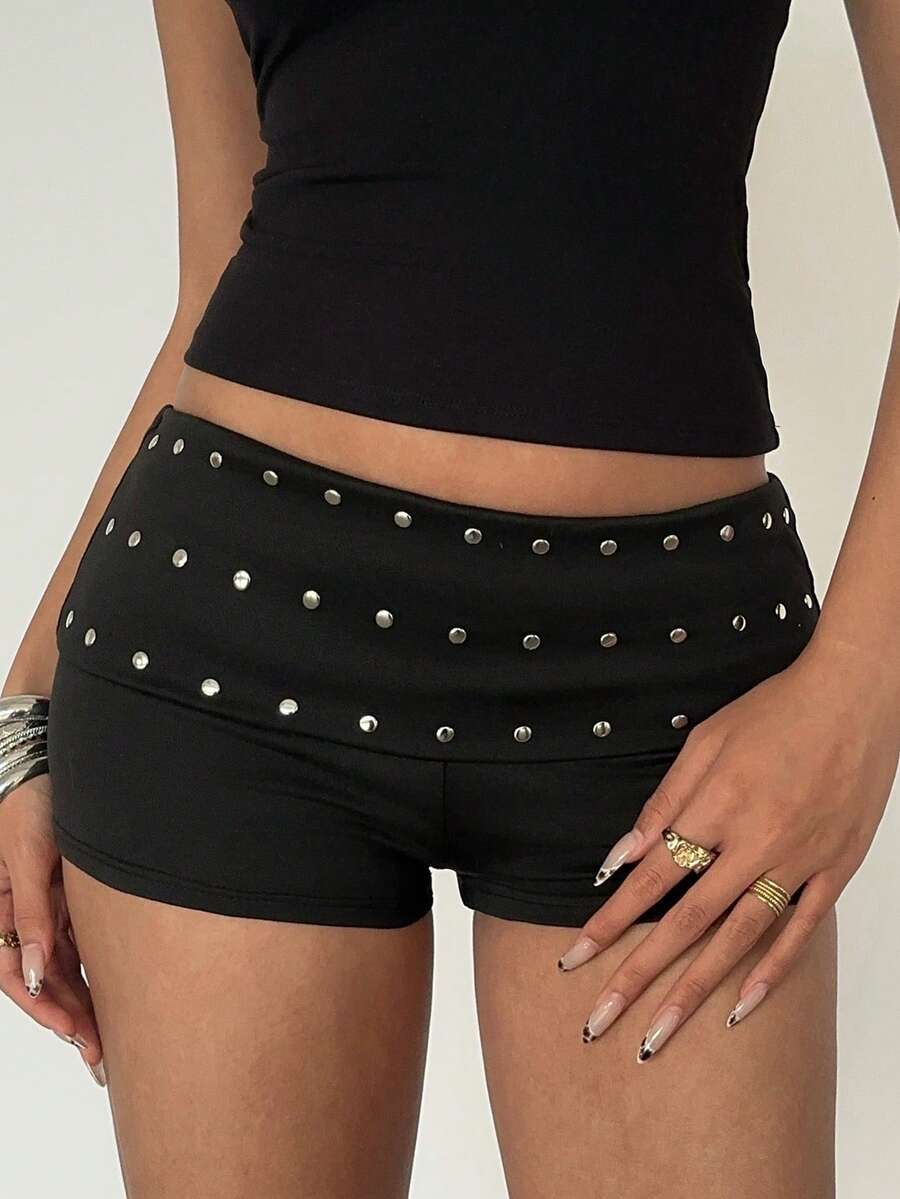 Women's ultra low waist mini shorts with rhinestone studded detailing, skinny fit, and mini length.