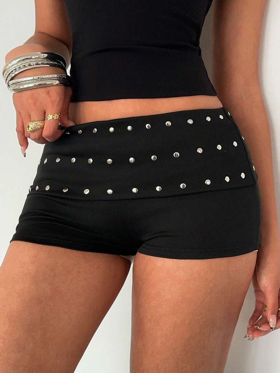 Women's studded PU ultra low waist mini shorts with zipper fly closure, skinny fit, mini length, and plain unlined design.
