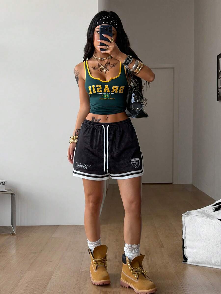 Women's black mesh track shorts featuring a drawstring waist, striped trim, and graphic letter print in a loose mini length.