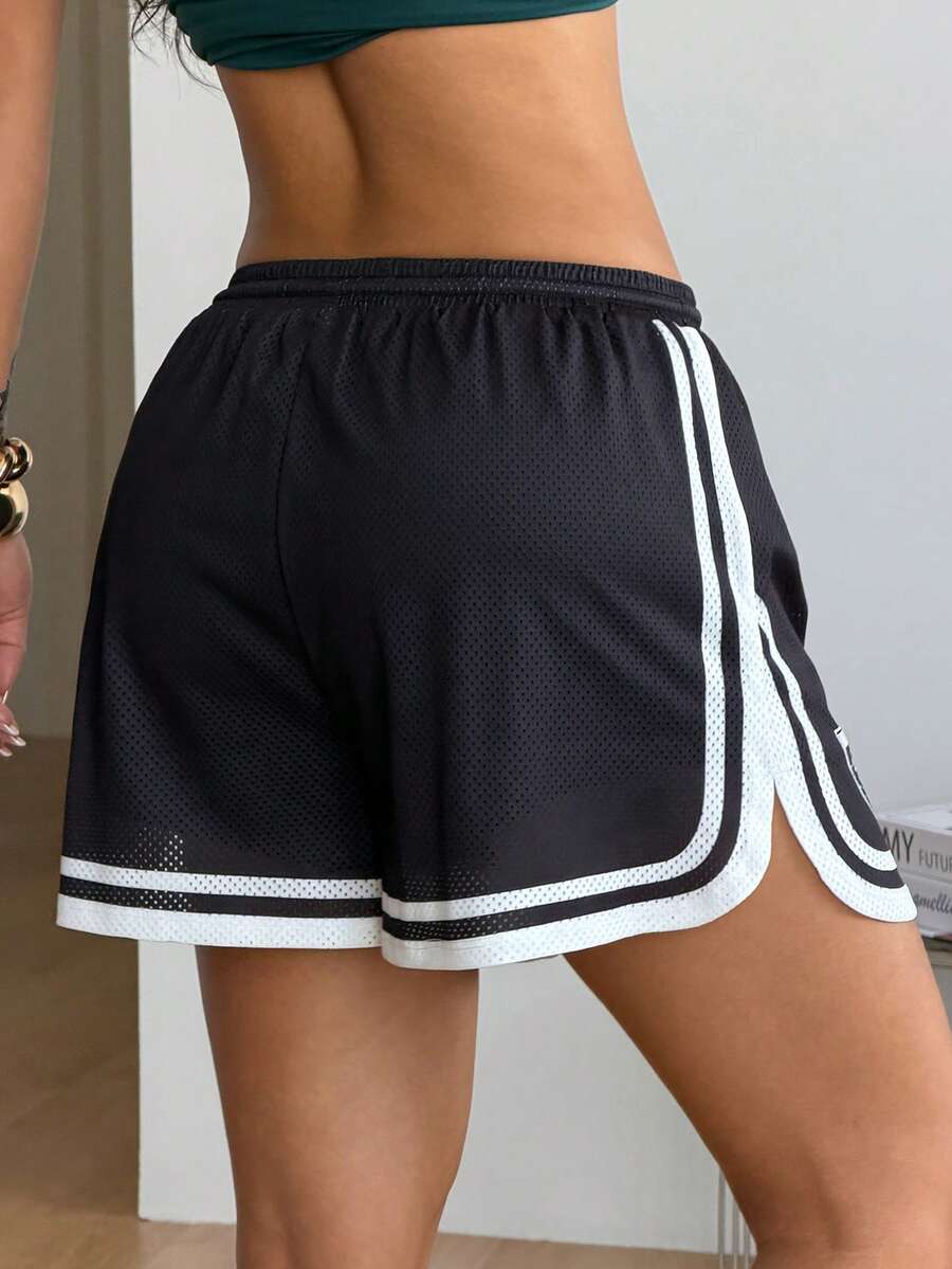 Women's black mesh track shorts featuring a drawstring waist, striped trim, and graphic letter print in a loose mini length.