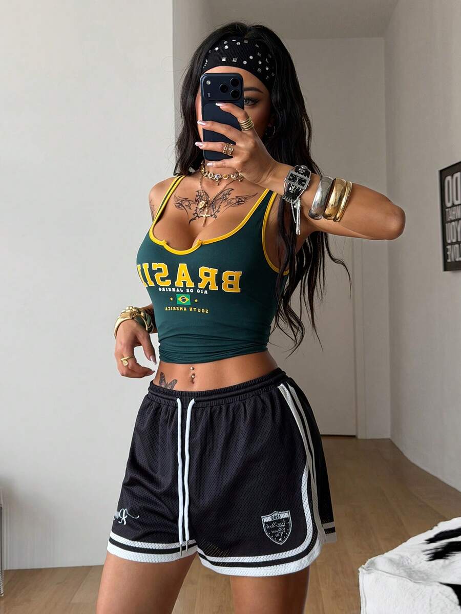 Women's black mesh track shorts featuring a drawstring waist, striped trim, and graphic letter print in a loose mini length.