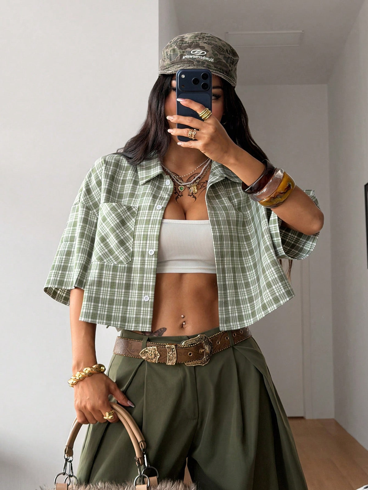 Women's plaid crop shirt with button front, chest pocket, short sleeves, and loose casual fit.