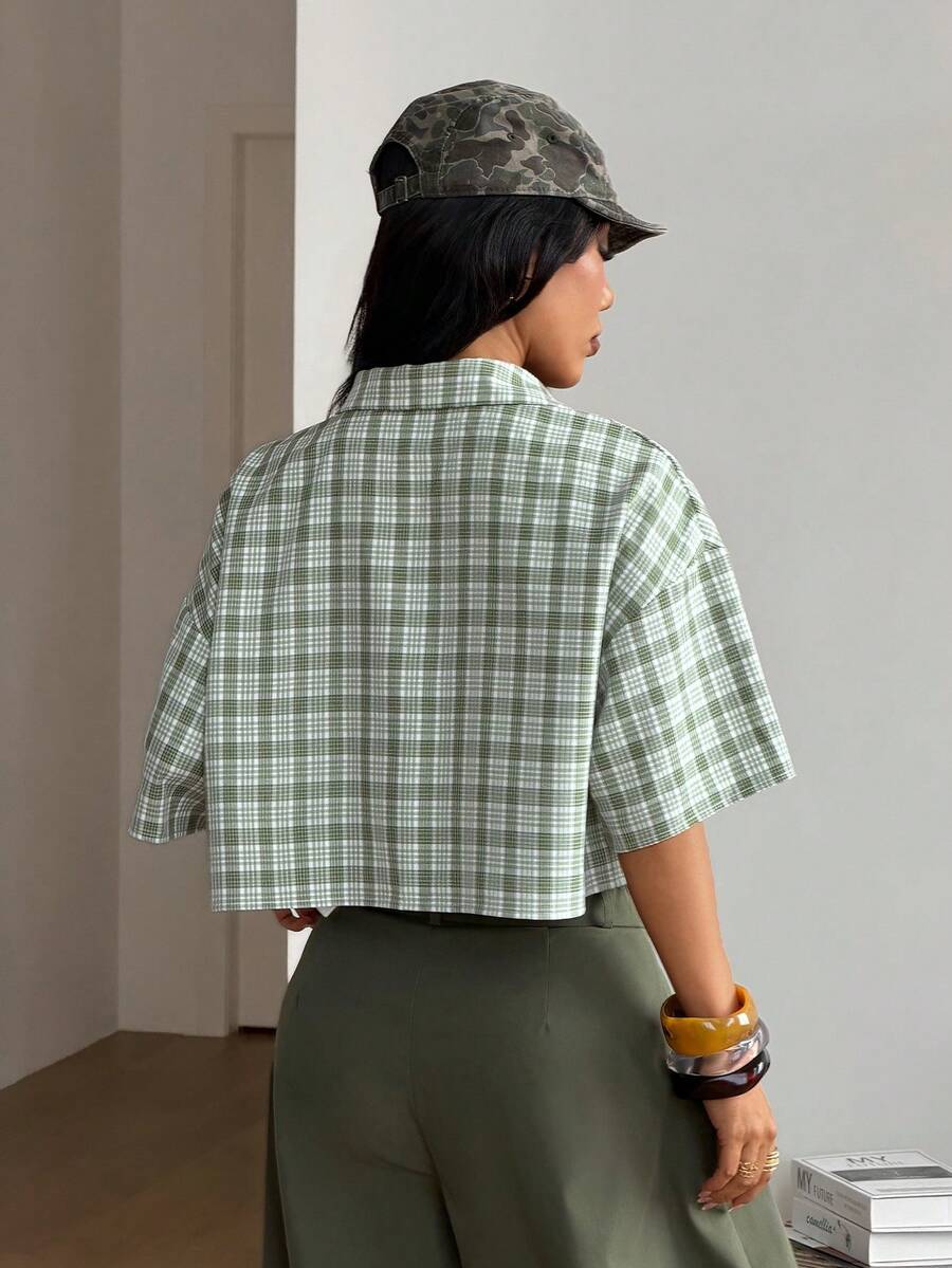 Women's plaid crop shirt with button front, chest pocket, short sleeves, and loose casual fit.