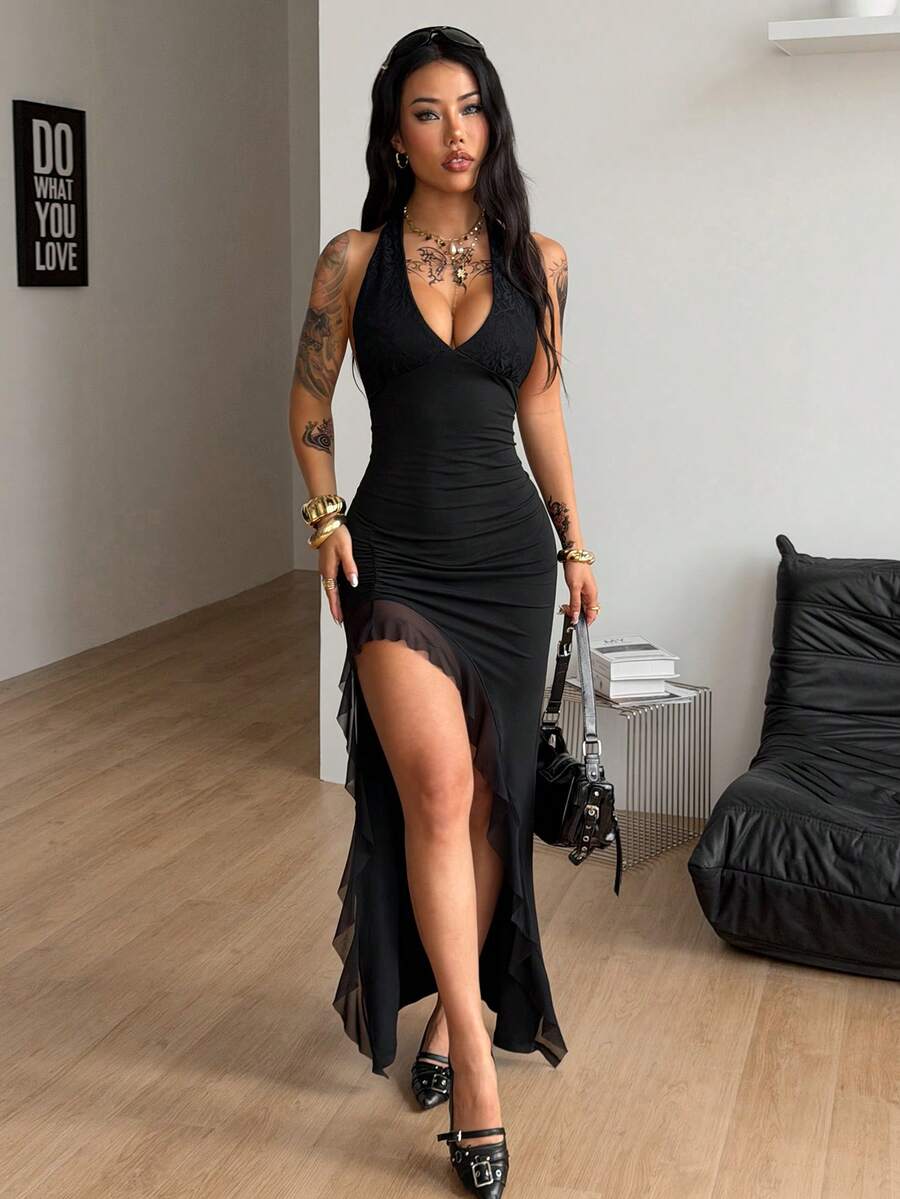 Women's slim fit black halter bodycon maxi dress featuring a sleeveless design and split thigh detail.