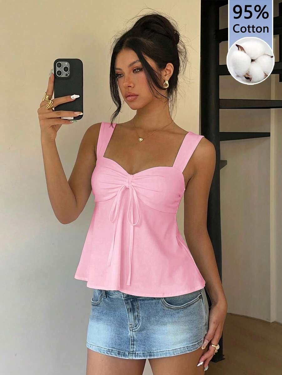 Women's white wide strap tank top with drawstring front, eyelet embroidery, ruffle hem, slim fit, and flared hem.