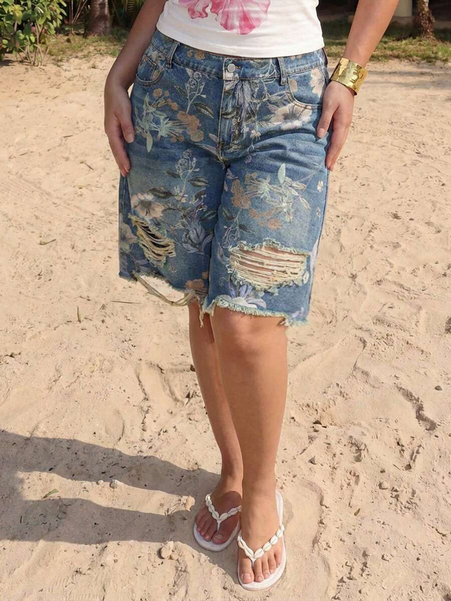 Women's loose wide-leg denim Bermuda shorts featuring vintage animal and paisley print with pockets and zipper fly.