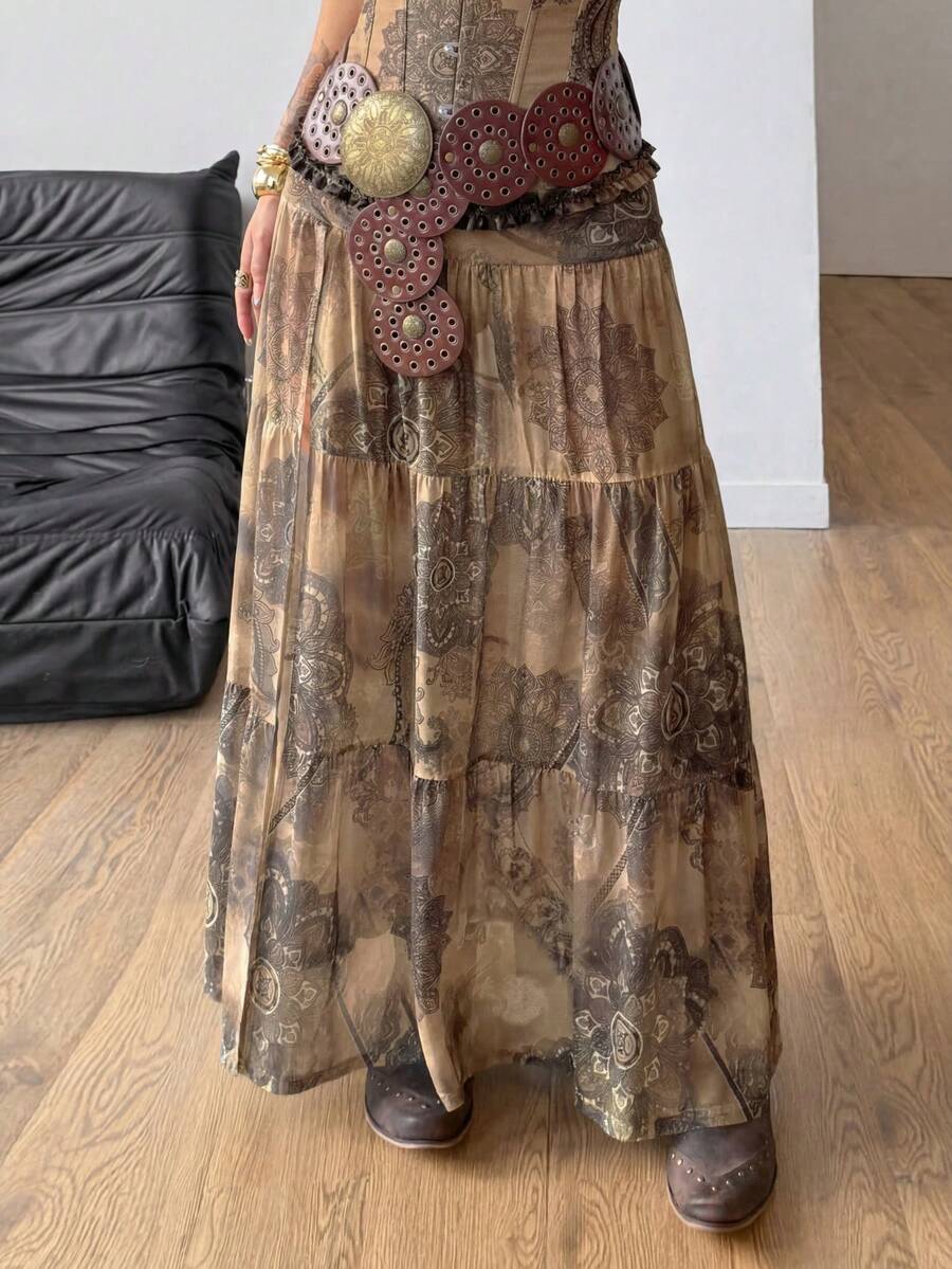 Women's low rise flared long skirt featuring an all-over print, split thigh accent, and textured semi-sheer fabric.
