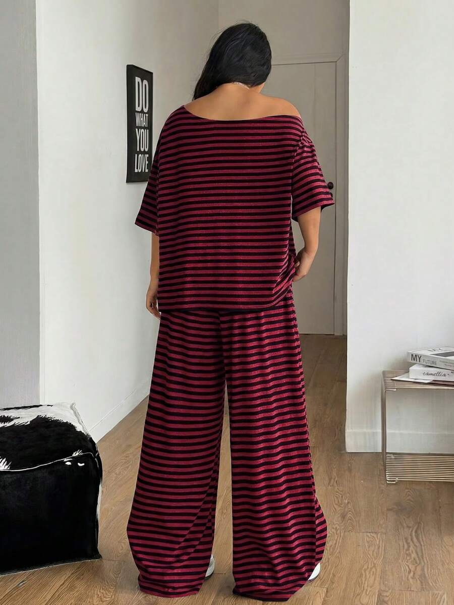 Women's casual two-piece outfit featuring a loose short-sleeve asymmetrical neck t-shirt and matching long wide leg pants with pockets.