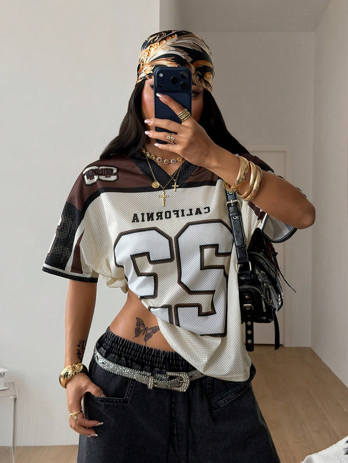 Women's oversized short sleeve graphic T-shirt with vintage digital geometric print, V-neck, and asymmetrical hem