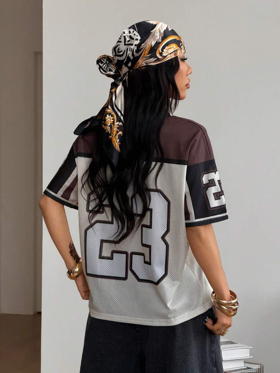 Women's oversized short sleeve graphic T-shirt with vintage digital geometric print, V-neck, and asymmetrical hem