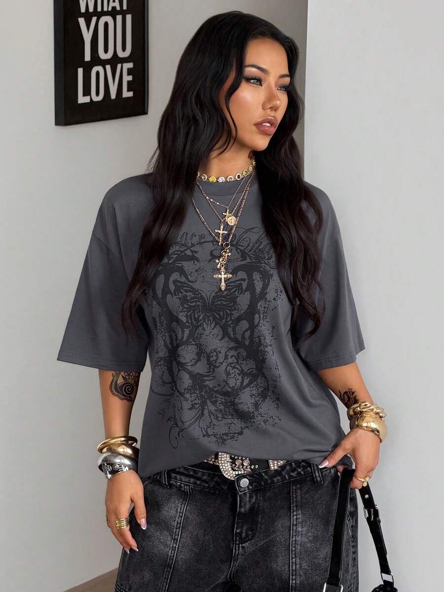 Unisex oversized grey graphic t-shirt featuring drop shoulder half sleeves, a round neckline, and a relaxed loose fit.