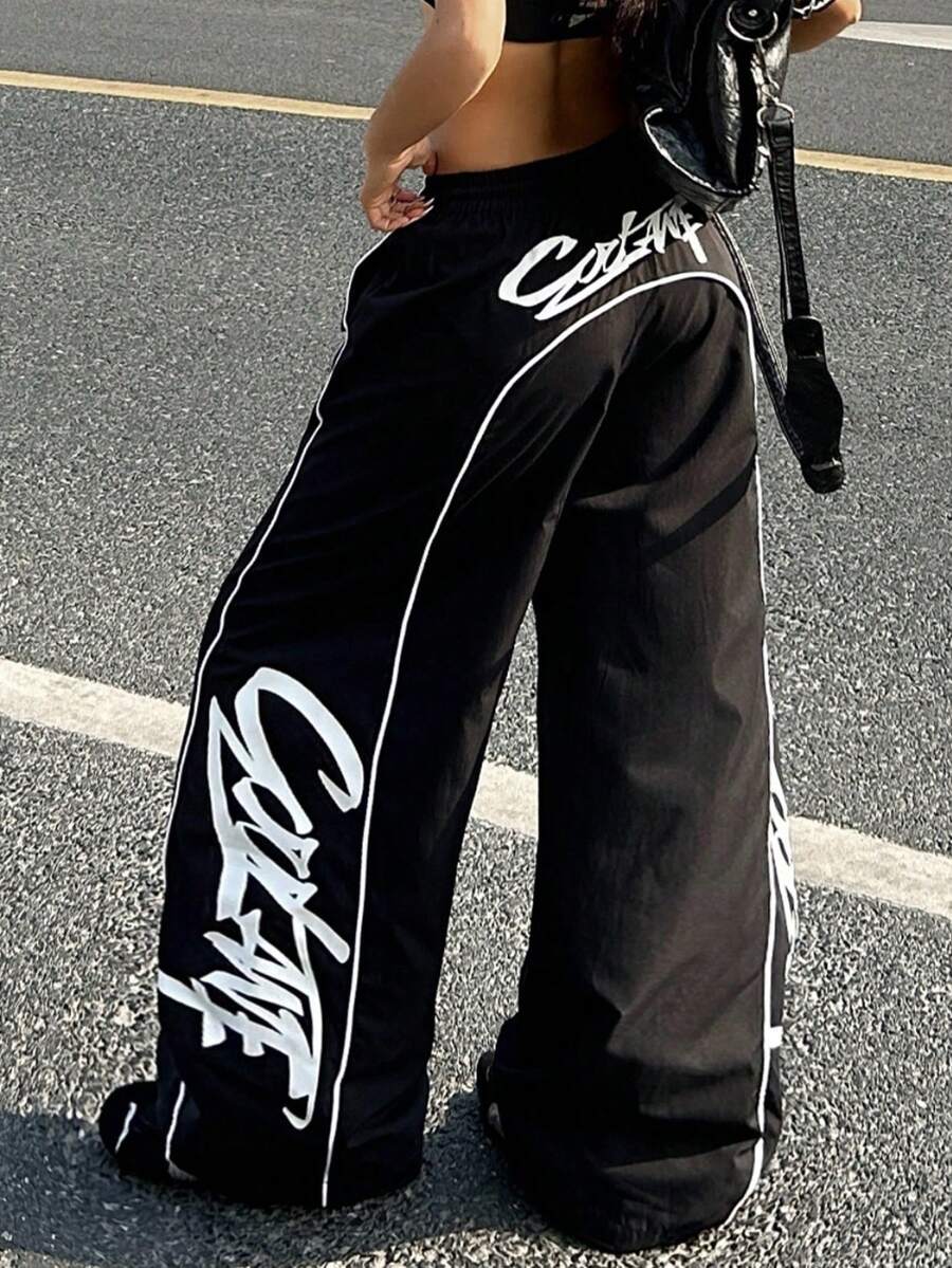 Women's black loose fit wide leg pants featuring an elastic waistband and side pockets with contrast binding.