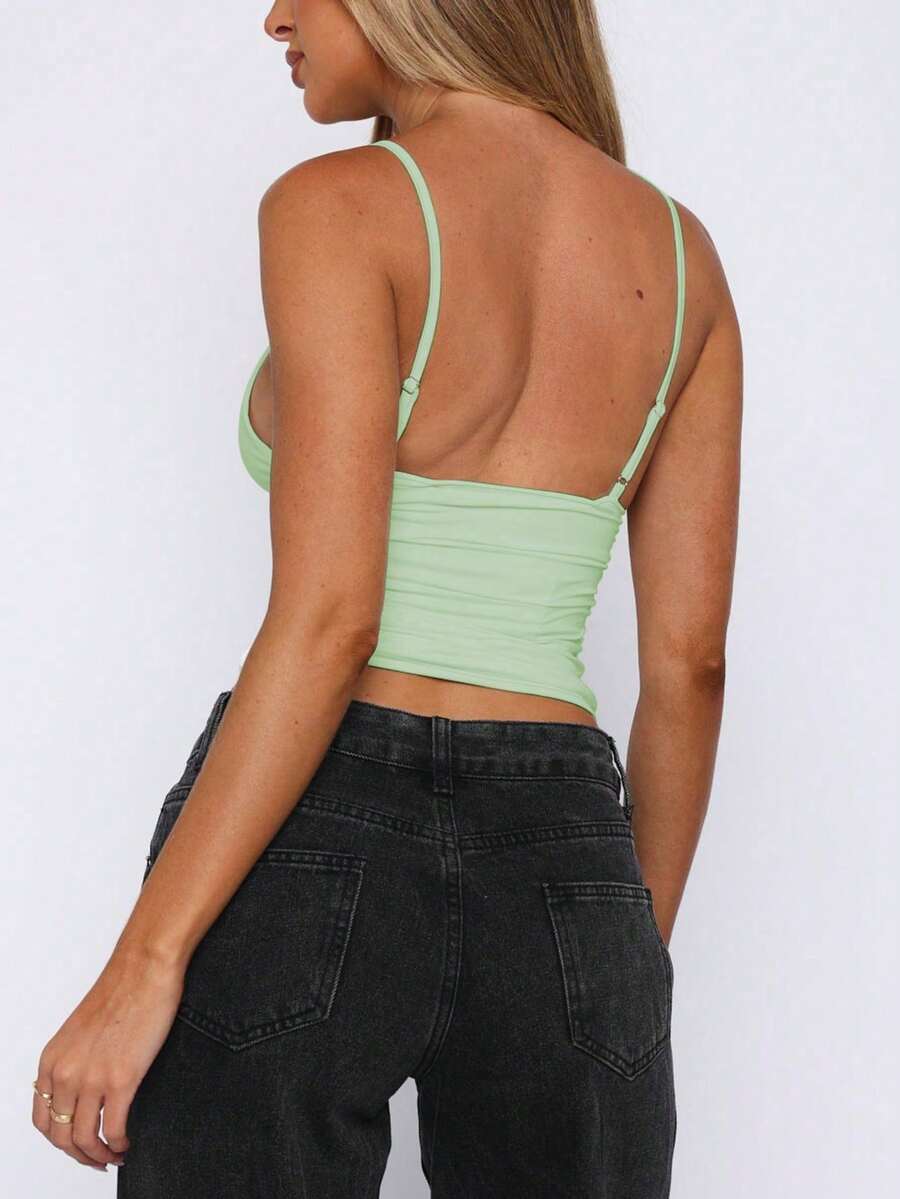Women's red V-neck backless cami crop top with ruched details in a slim fit knitted style.