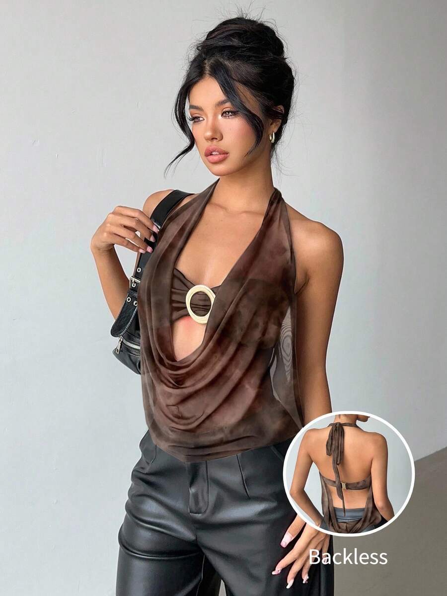 Brown and white polka dot semi-sheer halter camisole top with a plunging neckline, backless design, draped front, and metallic studded embellishments.