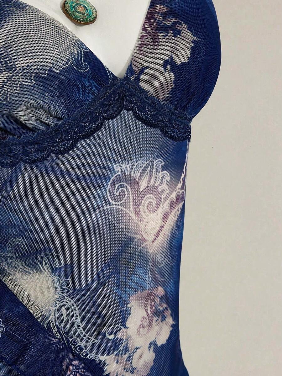Women's graphic print camisole top featuring thin spaghetti straps, a backless cut, and an asymmetrical hem.