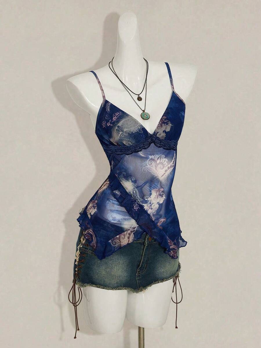 Women's graphic print camisole top featuring thin spaghetti straps, a backless cut, and an asymmetrical hem.